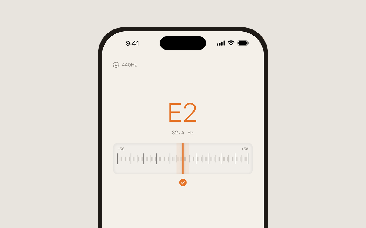 Dial guitar tuner showing E2 at 82.4 Hz